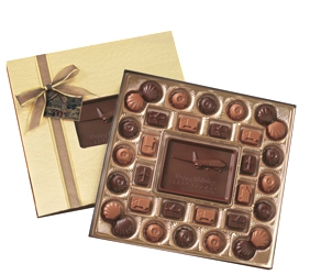 Medium Custom Chocolate Delights Gift Box - Made from milk and dark Swiss chocolate, this gift box is large enough for a group or deserving individual. The customized centerpiece is nestled amongst 32 chocolate pieces.